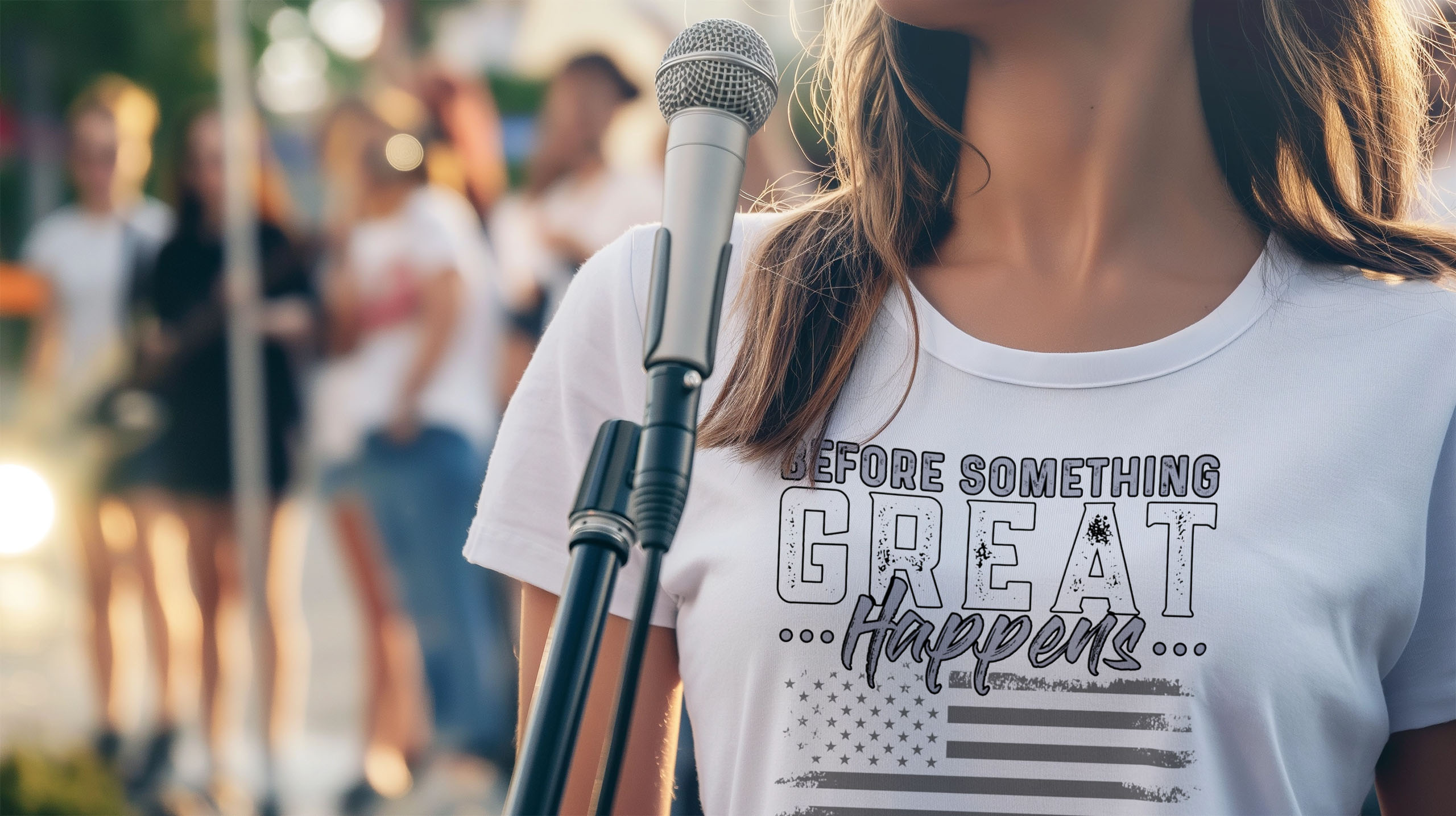 Lovely thought-criminal woman standing at the microphone addressing a freedom crowd in a white OrwellianWear t-shirt.